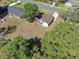 An aerial view of a home with a big backyard with a big tree at 3360 Cross Fox Dr, Mulberry, FL 33860