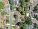 A neighborhood aerial view shows a property surrounded by mature trees and neighboring houses at 3360 Cross Fox Dr, Mulberry, FL 33860