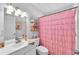 Bathroom with a single sink vanity and pink shower curtain at 3360 Cross Fox Dr, Mulberry, FL 33860