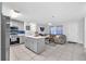 Modern kitchen open to the living room, featuring stainless steel appliances and a center island at 3360 Cross Fox Dr, Mulberry, FL 33860