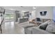 Bright and airy living space showcasing an open layout, stylish gray furnishings, and access to outdoor patio at 3360 Cross Fox Dr, Mulberry, FL 33860