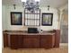 A serving area with cabinets, countertop, and a microwave oven with decorative art at 11305 Sw 186Th Cir, Dunnellon, FL 34432