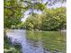 Tranquil river view with clear water, lush trees, and boats creating a peaceful waterfront scenery at 11305 Sw 186Th Cir, Dunnellon, FL 34432