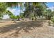 View of the backyard with mature trees and house at 1895 Emerson Ave, Bartow, FL 33830