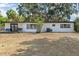 Backyard view of the exterior elevation and a small deck at 1895 Emerson Ave, Bartow, FL 33830