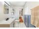 Bright bathroom with tiled floors, white vanity, and blue wainscoting at 1895 Emerson Ave, Bartow, FL 33830