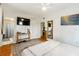 Relaxing bedroom with hardwood floors, television, closet, and decorative mirror at 1895 Emerson Ave, Bartow, FL 33830