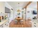 Bright dining room with wood table, white chairs, wood beam, and hardwood flooring at 1895 Emerson Ave, Bartow, FL 33830