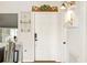Charming entryway with a white door and decorative accents on the walls at 1895 Emerson Ave, Bartow, FL 33830
