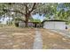 Charming single-story home with attached garage and a large oak tree in the front yard at 1895 Emerson Ave, Bartow, FL 33830
