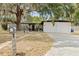 Charming single-story home showcasing a well-manicured lawn, mature trees, and a convenient two-car garage at 1895 Emerson Ave, Bartow, FL 33830
