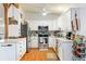 Bright kitchen featuring white cabinets, stainless steel appliances, and wood flooring at 1895 Emerson Ave, Bartow, FL 33830