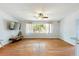 Bright living room with wood floors, a large window and neutral-colored walls at 1895 Emerson Ave, Bartow, FL 33830