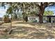 Lush yard showcasing a charming single-story home with mature trees providing ample shade and curb appeal at 1895 Emerson Ave, Bartow, FL 33830
