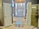 Bright bathroom featuring a soaking tub, walk-in shower, and window with shutters at 242 Prestwick Dr, Davenport, FL 33897