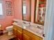 Bathroom with dual sinks, toilet, and shower with a floral shower curtain at 242 Prestwick Dr, Davenport, FL 33897