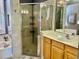 Modern bathroom with glass-enclosed shower, tiled floors, and a spacious vanity at 242 Prestwick Dr, Davenport, FL 33897
