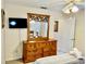 Bedroom with dresser, mirror, TV, ceiling fan and door at 242 Prestwick Dr, Davenport, FL 33897