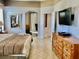 Bright primary bedroom featuring tile floors, a dresser, and views into other rooms at 242 Prestwick Dr, Davenport, FL 33897