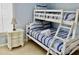 Bedroom with bunk beds, side table, and window at 242 Prestwick Dr, Davenport, FL 33897