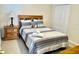 Bedroom with queen bed, nightstand, lamp and closet at 242 Prestwick Dr, Davenport, FL 33897