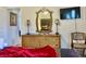Bedroom with dresser, mirror, TV and chair at 242 Prestwick Dr, Davenport, FL 33897