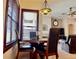 Dining area features dark wood table with seating for four and decorative lighting fixture at 242 Prestwick Dr, Davenport, FL 33897
