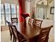 Formal dining room with a dark wood table and seating for six, under ornate lighting fixture at 242 Prestwick Dr, Davenport, FL 33897