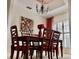 Dining room features a dark wood table and seating for six with unique decorative wall art at 242 Prestwick Dr, Davenport, FL 33897