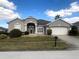 Charming single-story home with manicured lawn and well-maintained landscaping at 242 Prestwick Dr, Davenport, FL 33897