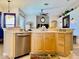 Bright eat-in kitchen with stainless steel dishwasher and light wood cabinetry at 242 Prestwick Dr, Davenport, FL 33897