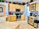 Well-appointed kitchen featuring stainless steel appliances, wooden cabinetry, and tile flooring at 242 Prestwick Dr, Davenport, FL 33897
