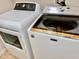 Laundry room featuring a white GE dryer and white Maytag washing machine at 242 Prestwick Dr, Davenport, FL 33897