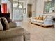Inviting living room with neutral decor and a view of the entry foyer at 242 Prestwick Dr, Davenport, FL 33897