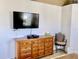 Spacious bedroom with a large television and chair at 242 Prestwick Dr, Davenport, FL 33897