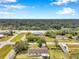 Aerial view of a home with an expansive yard, a long driveway, and mature shade trees at 424 Forest Glen Ave, Lakeland, FL 33813