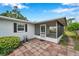 Enclosed patio with brick flooring offering a relaxing outdoor living space at 424 Forest Glen Ave, Lakeland, FL 33813