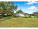 Spacious backyard with ample greenery, lush landscaping and beautiful, mature trees at 424 Forest Glen Ave, Lakeland, FL 33813