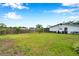 Large backyard enclosed by a wood fence and lush green lawn at 424 Forest Glen Ave, Lakeland, FL 33813
