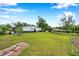 Spacious backyard with a well-maintained lawn and border hedges at 424 Forest Glen Ave, Lakeland, FL 33813
