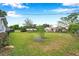 View of the backyard, featuring lush green grass and some landscaping at 424 Forest Glen Ave, Lakeland, FL 33813