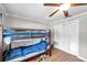 Bedroom with bunk beds, a ceiling fan, and closet doors; great for shared living at 424 Forest Glen Ave, Lakeland, FL 33813