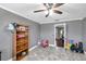 This bedroom features wood floors, a ceiling fan and a doorway that leads to another room at 424 Forest Glen Ave, Lakeland, FL 33813