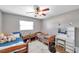 This bedroom features two beds, side tables, a ceiling fan and a vanity table with storage and mirror at 424 Forest Glen Ave, Lakeland, FL 33813