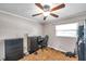 Bedroom with a ceiling fan, window, a gaming desk, and drawer sets; great for relaxing at 424 Forest Glen Ave, Lakeland, FL 33813