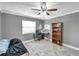 This bedroom features wood floors, a ceiling fan and a large window providing natural light at 424 Forest Glen Ave, Lakeland, FL 33813