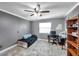 This bedroom features wood floors, a ceiling fan and a large window providing natural light at 424 Forest Glen Ave, Lakeland, FL 33813