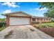 Ample driveway leading to a well-maintained home with an attached garage and manicured landscaping at 424 Forest Glen Ave, Lakeland, FL 33813
