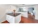 Kitchen island with a granite countertop and a view of the living room, hardwood floors at 424 Forest Glen Ave, Lakeland, FL 33813