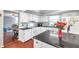 Bright kitchen with white cabinets, black countertops, and hardwood floors at 424 Forest Glen Ave, Lakeland, FL 33813